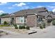 Inviting home with stone and siding, well-kept landscaping, and a walkway leading to the entrance at 14916 E Crestridge Pl, Centennial, CO 80015