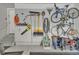 Well-organized garage with slatwall storage system for tools and bikes, epoxy floor, and access door at 14916 E Crestridge Pl, Centennial, CO 80015