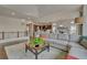 Open-concept living space with a sectional sofa, coffee table, and seamless flow into the modern kitchen at 14916 E Crestridge Pl, Centennial, CO 80015