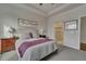 Comfortable bedroom with neutral color scheme, large window, and en-suite bathroom access at 14916 E Crestridge Pl, Centennial, CO 80015