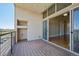 Balcony view to living space, showing sliding doors, wood floors and outdoor views of nature at 307 Inverness S Way # 307, Englewood, CO 80112