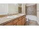 Bathroom with double sinks, tile floor, and shower-tub combo at 307 Inverness S Way # 307, Englewood, CO 80112