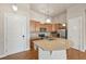 Modern kitchen featuring stainless steel appliances, wooden cabinets, and a large island with a sink at 307 Inverness S Way # 307, Englewood, CO 80112