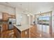 Open kitchen with island, stainless steel appliances, and hardwood floors, connects to great room at 307 Inverness S Way # 307, Englewood, CO 80112