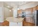 A well-equipped kitchen boasts wooden cabinets, stainless steel appliances, and a center island with a sink at 307 Inverness S Way # 307, Englewood, CO 80112