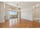 Open living area with hardwood floors, a fireplace, a ceiling fan, and lots of natural light at 307 Inverness S Way # 307, Englewood, CO 80112