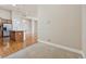Living room with hardwood floors flowing into the kitchen area with a stone counter at 307 Inverness S Way # 307, Englewood, CO 80112