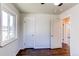 Bedroom features a window and door, plus beautiful hardwood floors throughout at 3311 S Eudora St, Denver, CO 80222