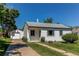 Quaint single-story home with a well-manicured lawn and detached garage at 3311 S Eudora St, Denver, CO 80222