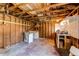 Unfinished basement area with washer, dryer, and open wooden beam ceiling at 3311 S Eudora St, Denver, CO 80222