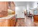 Elegant bar area with custom wood cabinets, glass shelving, and stone backsplash at 36920 Forest Trl, Elizabeth, CO 80107