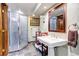 Bathroom with a glass shower, pedestal sink, and dark tile floor at 36920 Forest Trl, Elizabeth, CO 80107