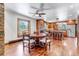 Cozy dining area with wood floors, view of the kitchen and table with seating for six at 36920 Forest Trl, Elizabeth, CO 80107