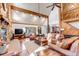 Comfortable living room featuring stone fireplace, wood beam ceilings, and lots of natural light at 36920 Forest Trl, Elizabeth, CO 80107