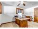 Bright home office featuring a large wooden desk and natural light at 36920 Forest Trl, Elizabeth, CO 80107