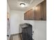 Functional laundry room features overhead cabinetry and modern washing machine at 1046 Acadia Cir, Erie, CO 80516