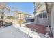 Small patio and fenced backyard with snow at 10219 Vine Ct, Thornton, CO 80229