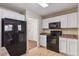 Modern kitchen with black appliances and white cabinets at 10219 Vine Ct, Thornton, CO 80229