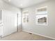 Bedroom with carpet, two windows, and a sliding door closet at 17355 E 91St Pl, Commerce City, CO 80022