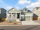 Two-story house with a green exterior, a two-car garage, and a front porch at 17355 E 91St Pl, Commerce City, CO 80022