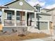 Two-story house with a green exterior, a two-car garage, and a front porch at 17355 E 91St Pl, Commerce City, CO 80022