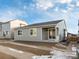 Rear view of house showing gray siding and patio at 17355 E 91St Pl, Commerce City, CO 80022