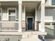 Dark-colored front door with sidelights and a white porch at 17355 E 91St Pl, Commerce City, CO 80022