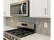 Stainless steel gas range with modern backsplash at 17355 E 91St Pl, Commerce City, CO 80022