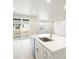 Kitchen island with sink, quartz countertop, and dishwasher at 17355 E 91St Pl, Commerce City, CO 80022