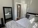 Bright bedroom features a comfortable bed, large mirror, and an en-suite bathroom at 215 E 11Th Ave # A11, Denver, CO 80203