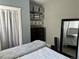 Bright bedroom boasts ample storage with shelves and a large dresser at 215 E 11Th Ave # A11, Denver, CO 80203