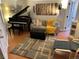 An open living room shows a grand piano, comfortable seating, and modern decor at 215 E 11Th Ave # A11, Denver, CO 80203