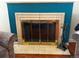 Classic fireplace with brass screen and tile surround at 3001 Pontiac St, Denver, CO 80207