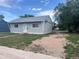 Image of the front of a light blue house with a gravel driveway on a sunny day at 804 S 1St Ave, Brighton, CO 80601