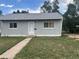 Charming single-story home with gray siding, a well-maintained yard, and a concrete walkway leading to the front door at 804 S 1St Ave, Brighton, CO 80601