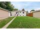 Wide-open backyard with a house and storage shed, perfect for outdoor activities and storage at 5635 Nebraska Way, Denver, CO 80224
