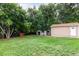 Lush backyard with mature trees, storage sheds and detached garage, offering shade and privacy at 5635 Nebraska Way, Denver, CO 80224