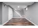 View of basement showcasing the stairway leading to upper level, vinyl floors, and painted walls at 5635 Nebraska Way, Denver, CO 80224