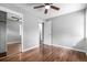 Neutral bedroom with ceiling fan, closet, and wood floors creating a serene space at 5635 Nebraska Way, Denver, CO 80224