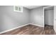 View of bedroom with new vinyl flooring, a double hung window and neutral gray paint color at 5635 Nebraska Way, Denver, CO 80224