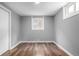 View of bedroom with new vinyl flooring, a double hung window and neutral gray paint color at 5635 Nebraska Way, Denver, CO 80224