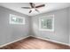 Bedroom featuring two windows, a ceiling fan, and hardwood floors at 5635 Nebraska Way, Denver, CO 80224