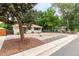 Single-story home with low-maintenance rock landscaping and mature trees at 5635 Nebraska Way, Denver, CO 80224