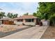Single-story home featuring a low maintenance rock yard and detached garage at 5635 Nebraska Way, Denver, CO 80224