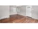 Naturally lit living room with refinished hardwood floors, adjacent to entry door at 5635 Nebraska Way, Denver, CO 80224