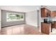 Living room showcasing refinished hardwood floors flowing into a well-appointed kitchen at 5635 Nebraska Way, Denver, CO 80224