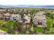 An aerial view showcases a neighborhood nestled in lush green landscaping with mountain views at 10632 Star Thistle Ct, Highlands Ranch, CO 80126