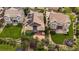 Aerial view of a beautiful home featuring solar panels, a patio and lush green landscaping at 10632 Star Thistle Ct, Highlands Ranch, CO 80126