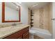 Bathroom features a stylish vanity with granite countertops, a tiled shower and bath combo at 10632 Star Thistle Ct, Highlands Ranch, CO 80126