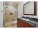 Modern bathroom showcasing an enclosed walk-in shower, beautiful tiles, a vanity, and elegant fixtures at 10632 Star Thistle Ct, Highlands Ranch, CO 80126